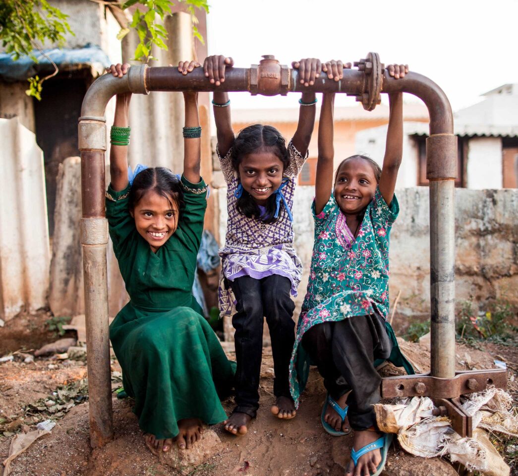 Three girls smiling and having fun.