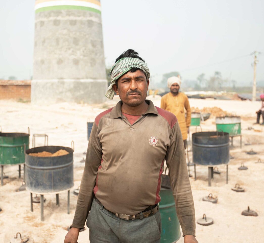 Man working outside at a brick factory.